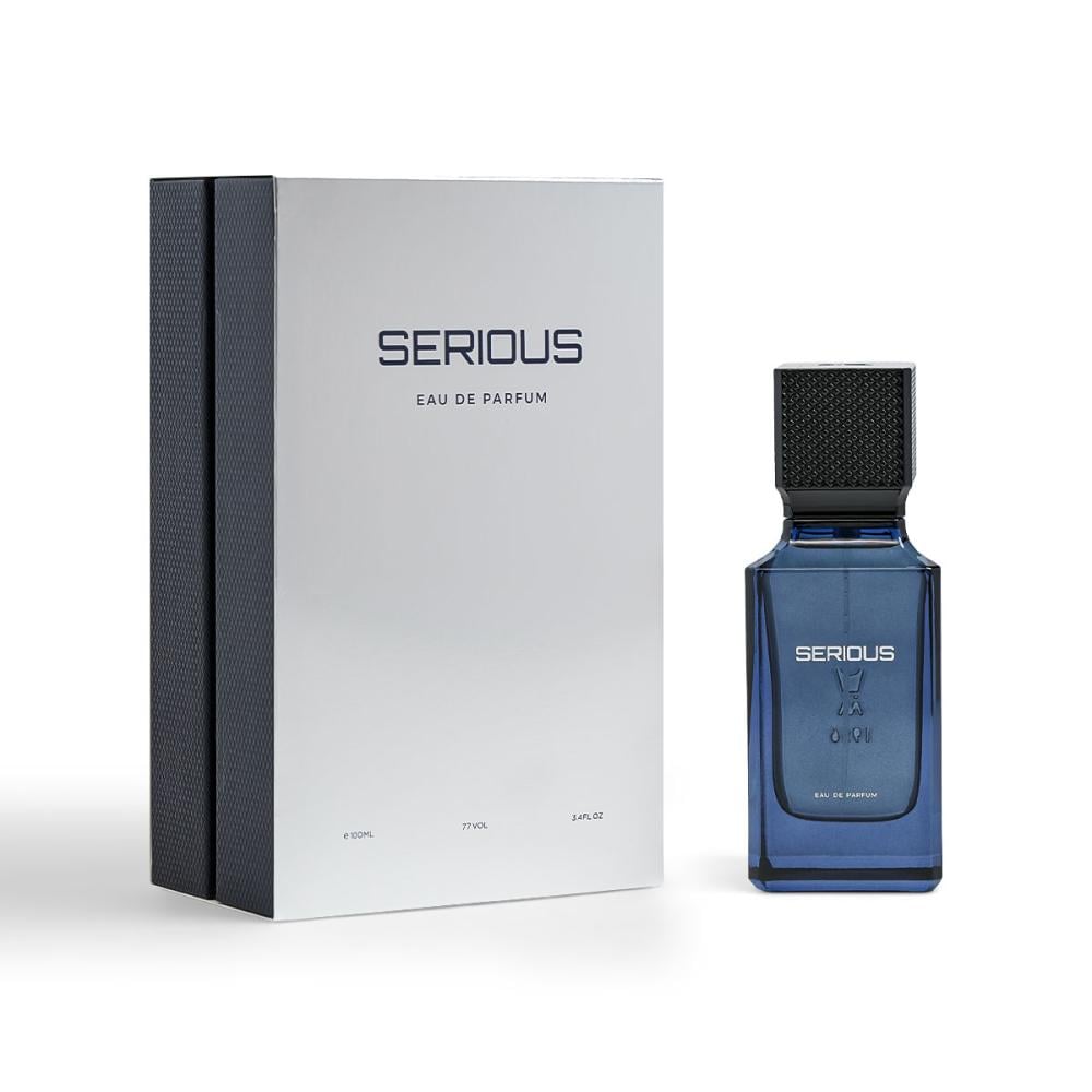 Al Majed Oud Serious 100ml EDP perfume blue bottle beside silver and textured dark blue outer packaging box at Beevora UK