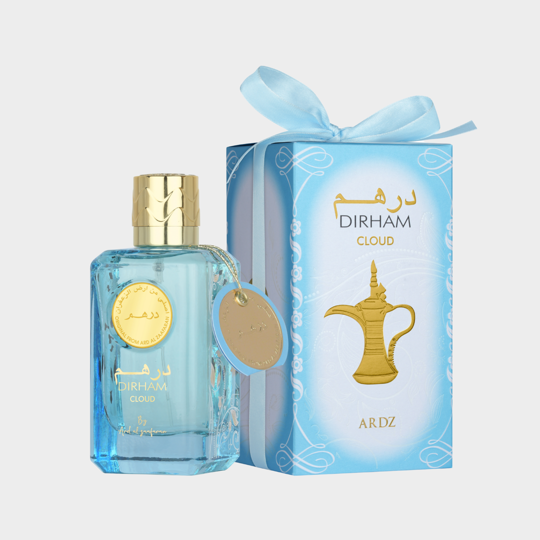 Dirham Cloud Blue perfume bottle with gold cap and matching packaging on a light gray background