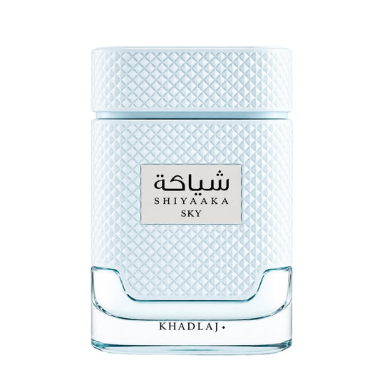 Shiyaaka Sky perfume bottle by Khadlaj, featuring a textured light blue and white diamond-patterned body with a clear glass base, on a white background.