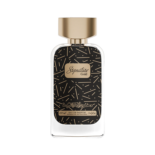 A bottle of Signature Gold Eau de Parfum with a black label patterned with gold lines, a gold cap, and gold lettering, set against a plain white background.